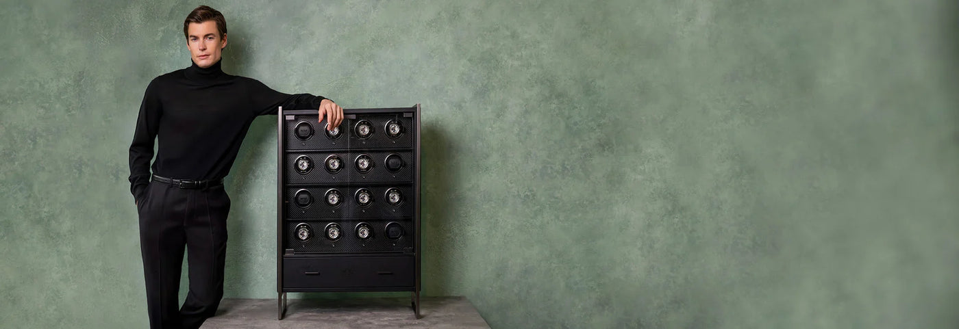 Collector beside a multi-watch winder cabinet