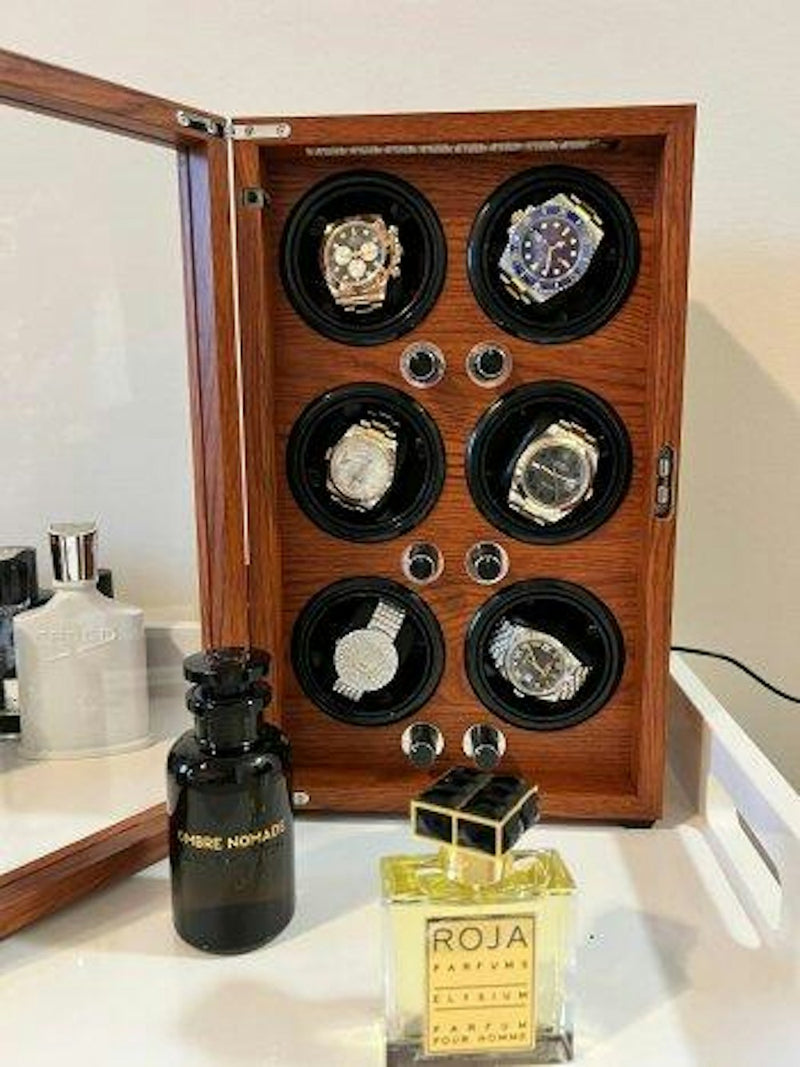 Open wooden six watch winder filled with automatic watches