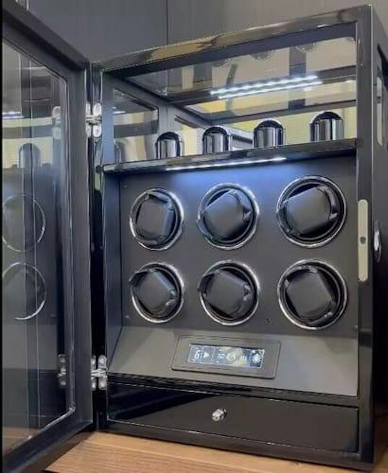 Black watch winder cabinet holding several automatic watches