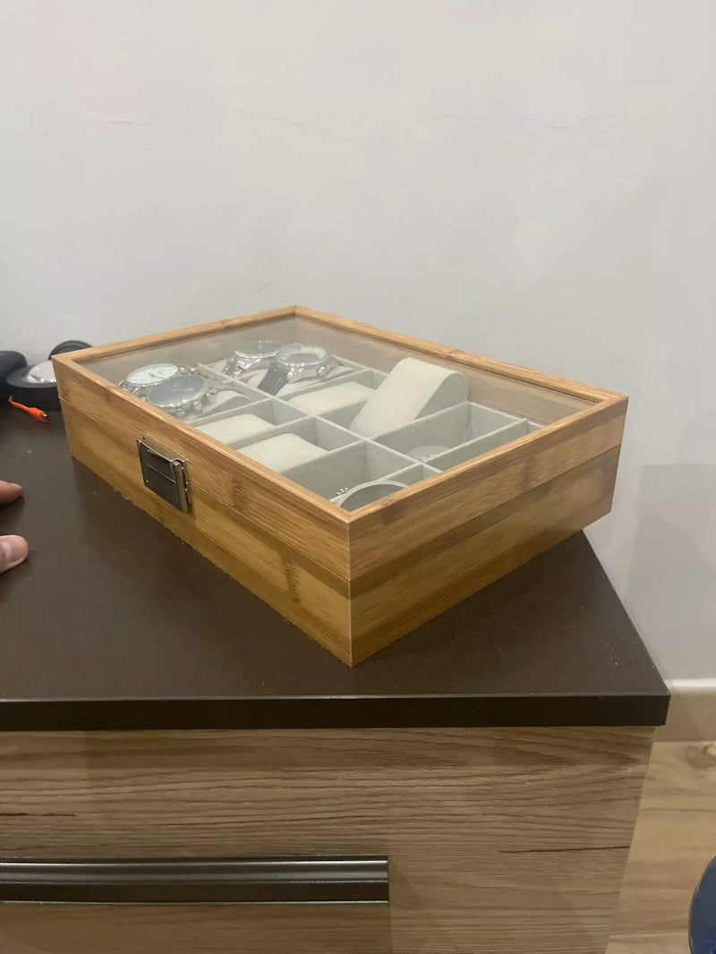 Bamboo watch box with glass lid showing a watch collection